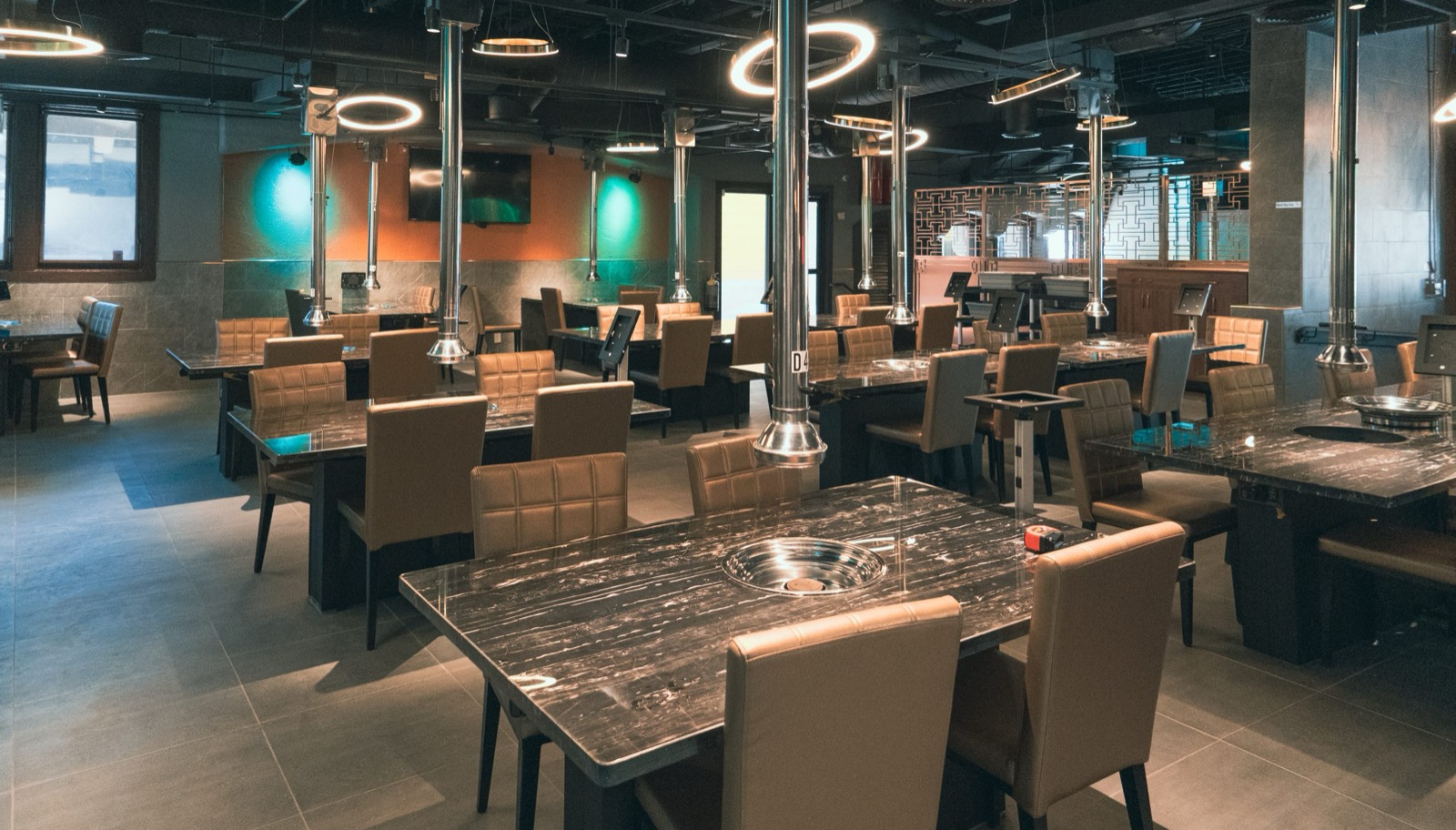 Modern Korean BBQ restaurant interior with grill tables and ambient lighting at Gaja Korean BBQ Oceanside